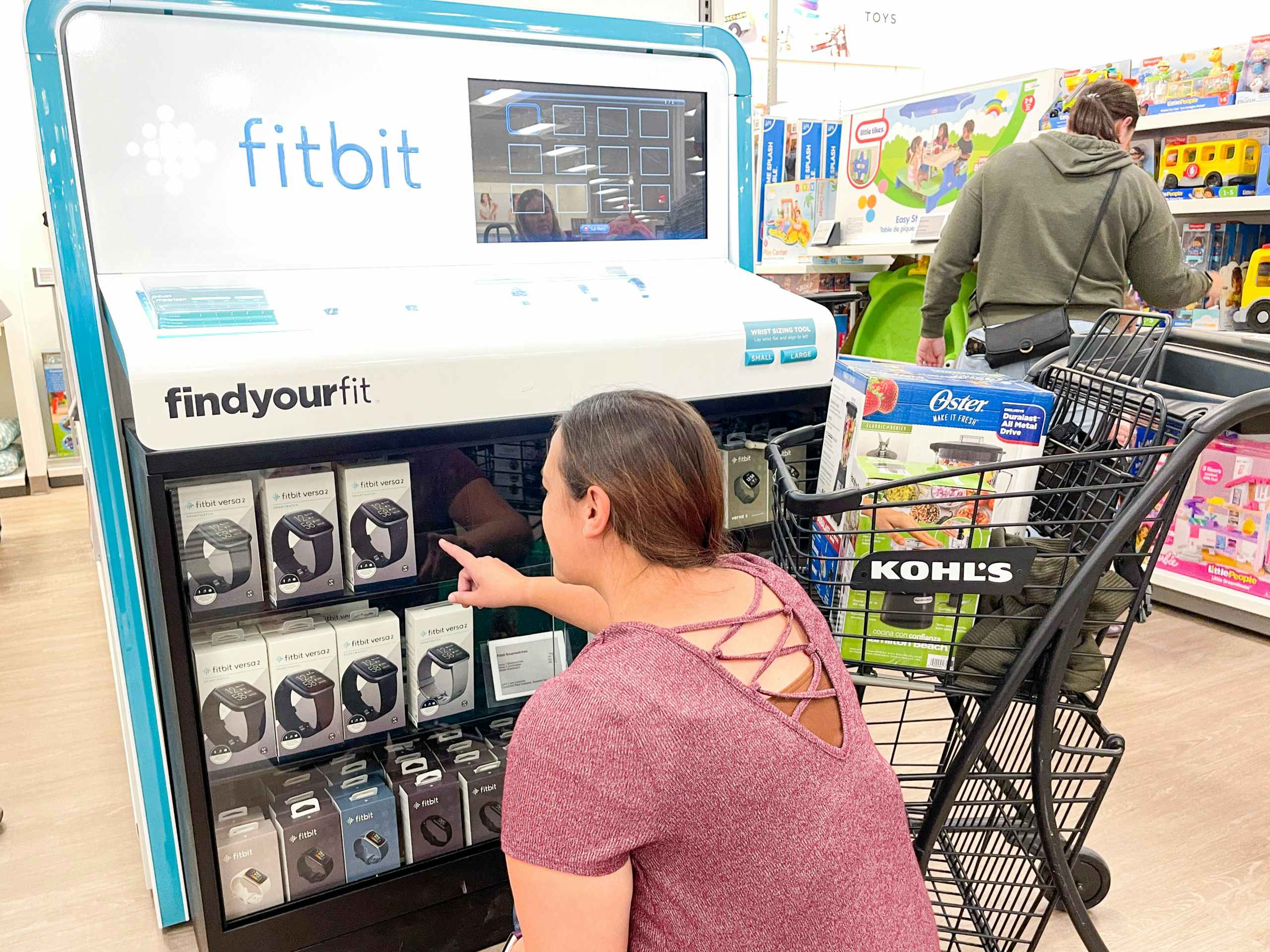 someone looking at fitbits at kohl's