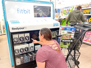 someone looking at fitbits at kohl's
