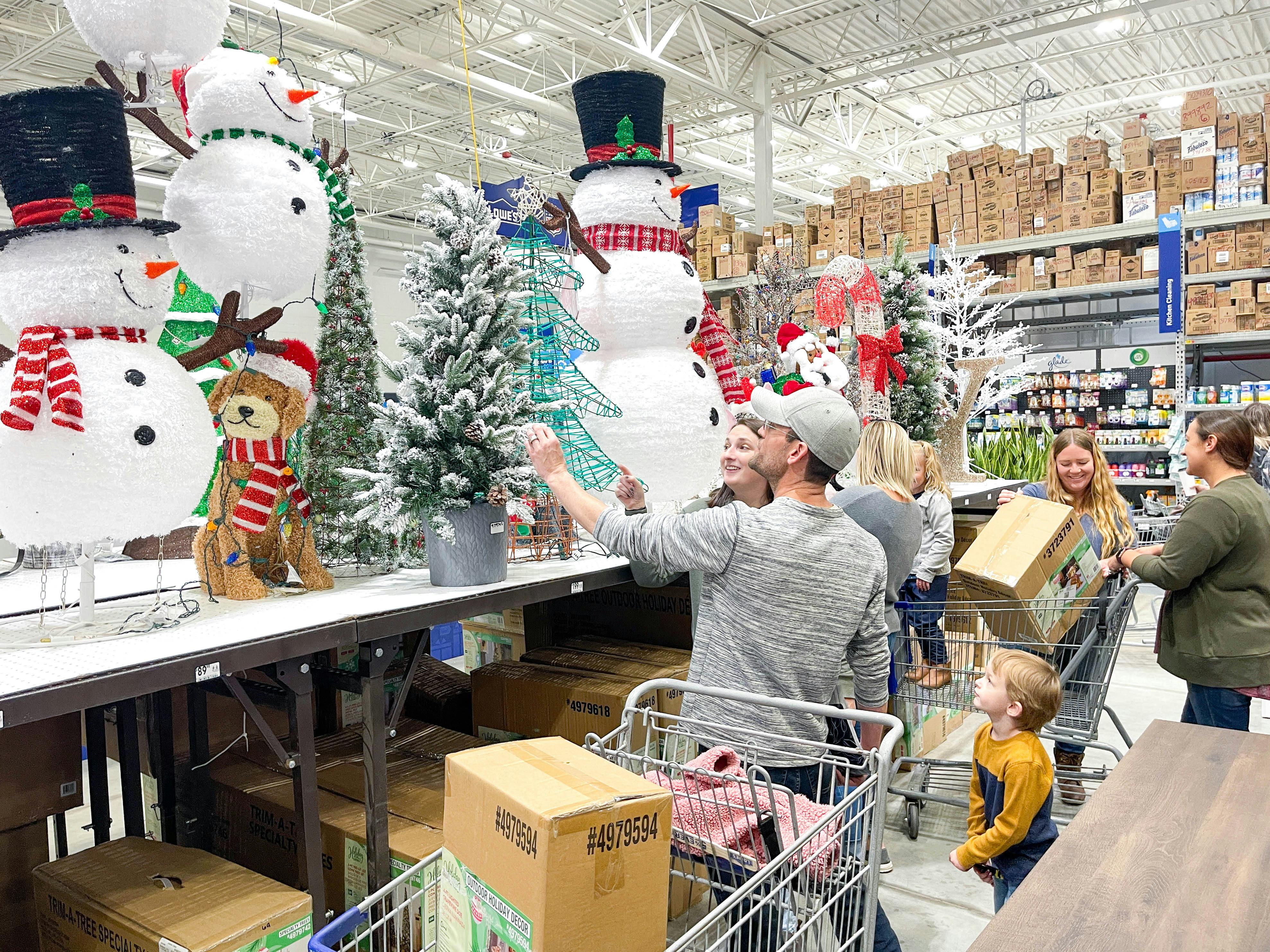A group of people looking at Christmas decor in Lowes.