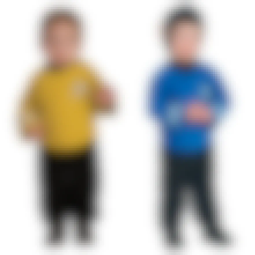 Two babies dressed as Captain Kirk and Spock on a white background.