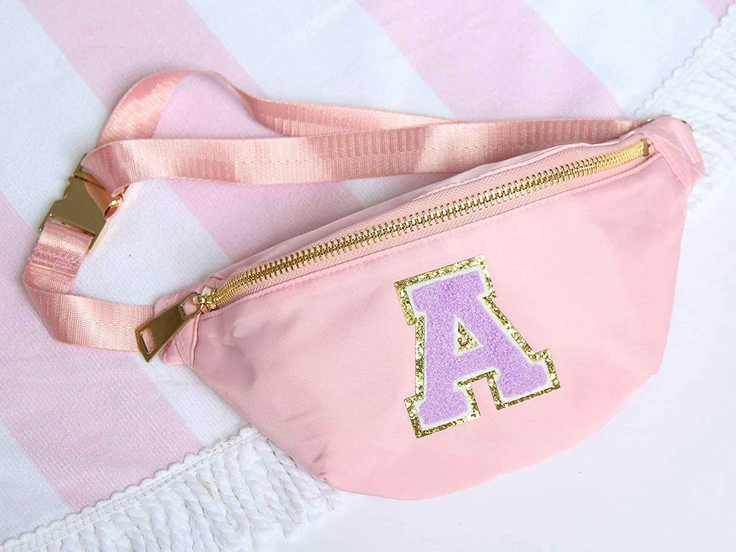 A pink fanny pack with the varsity letter "A" on the front.