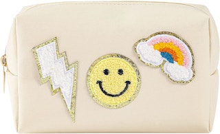 A makeup pouch with three custom patches on the front of it.