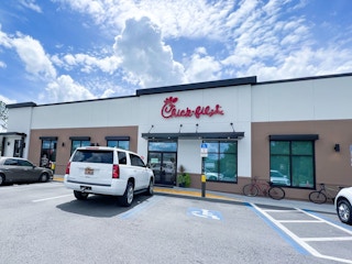 Cars parked outside of a Chick-fil-A restaurant