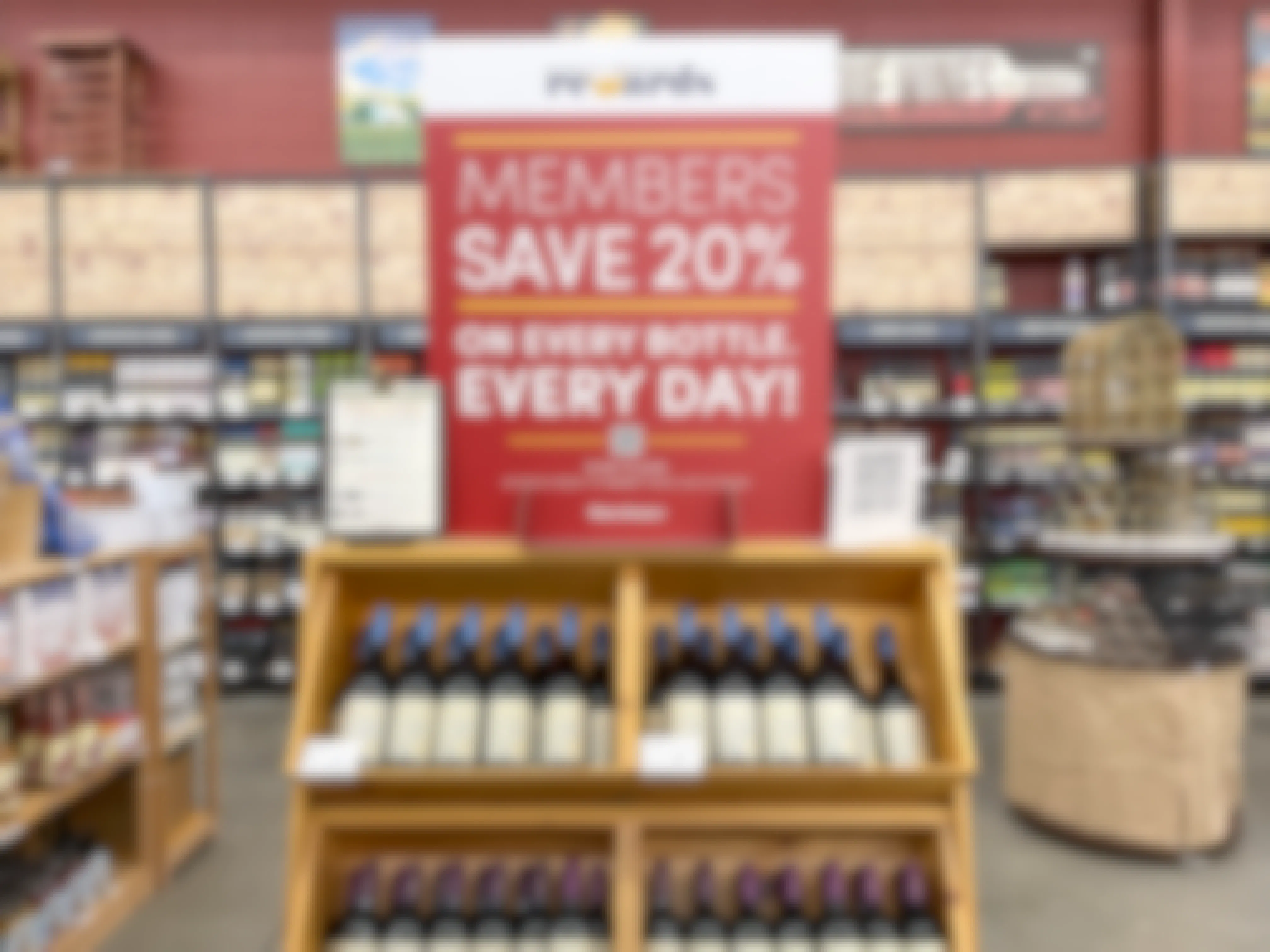 A sign for 20% off wine with the Cost Plus World Market rewards program membership.