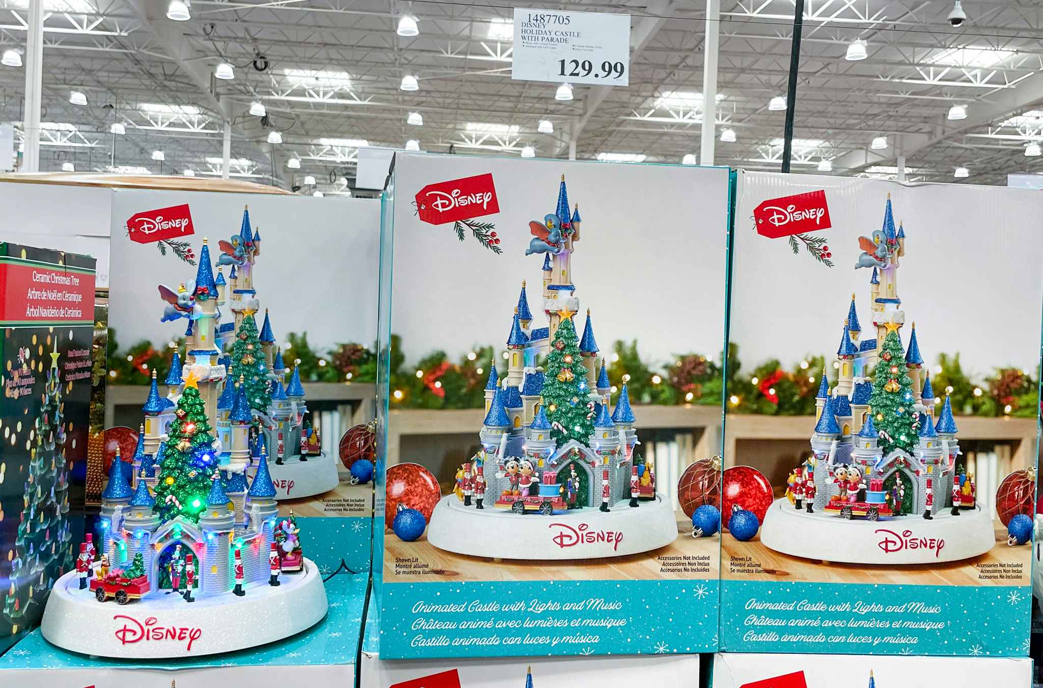 disney holiday castle on display at costco with sales sign