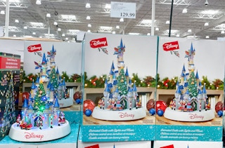 disney holiday castle on display at costco with sales sign