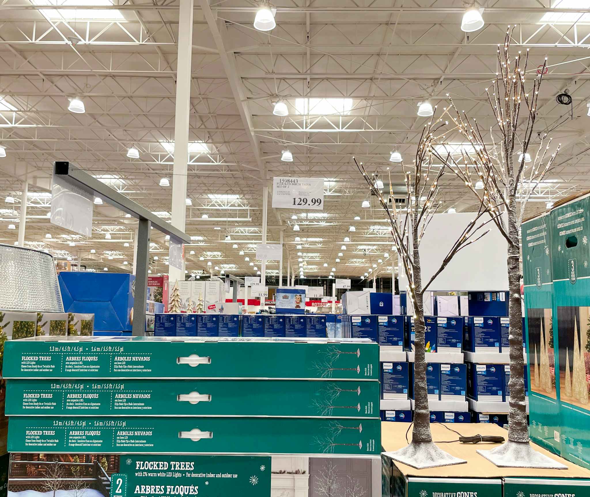 pre-lit christmas birch trees on display with sale sign at costco