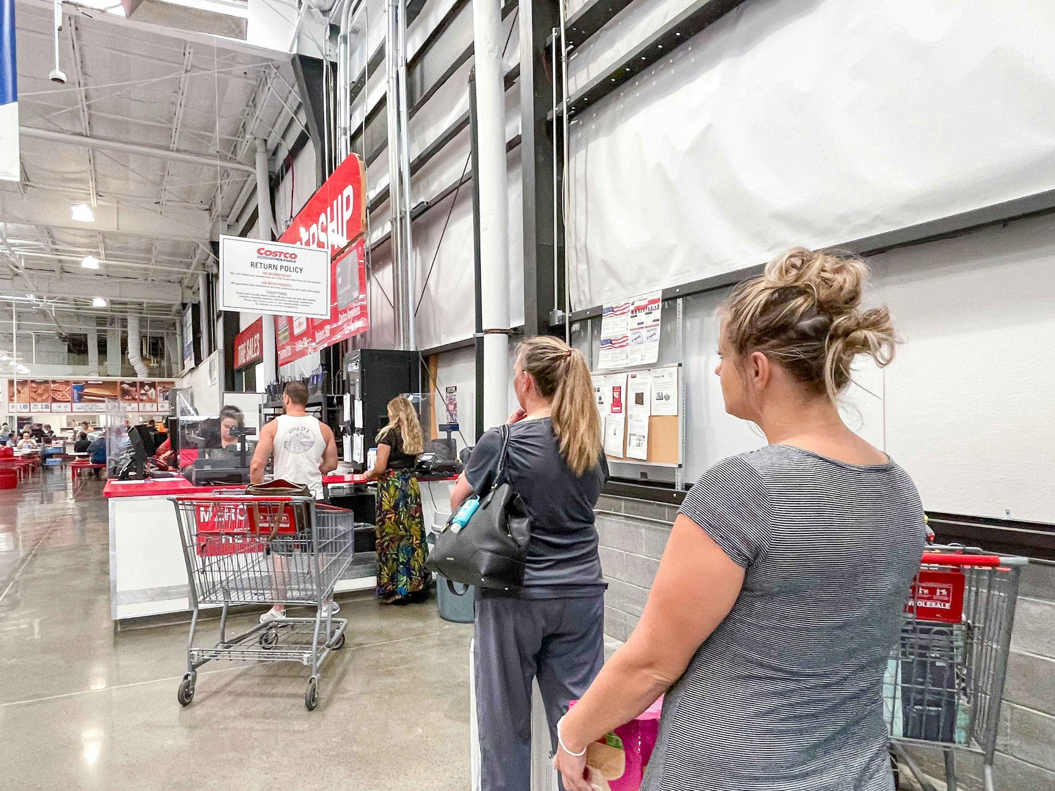a woman standing in costco return line