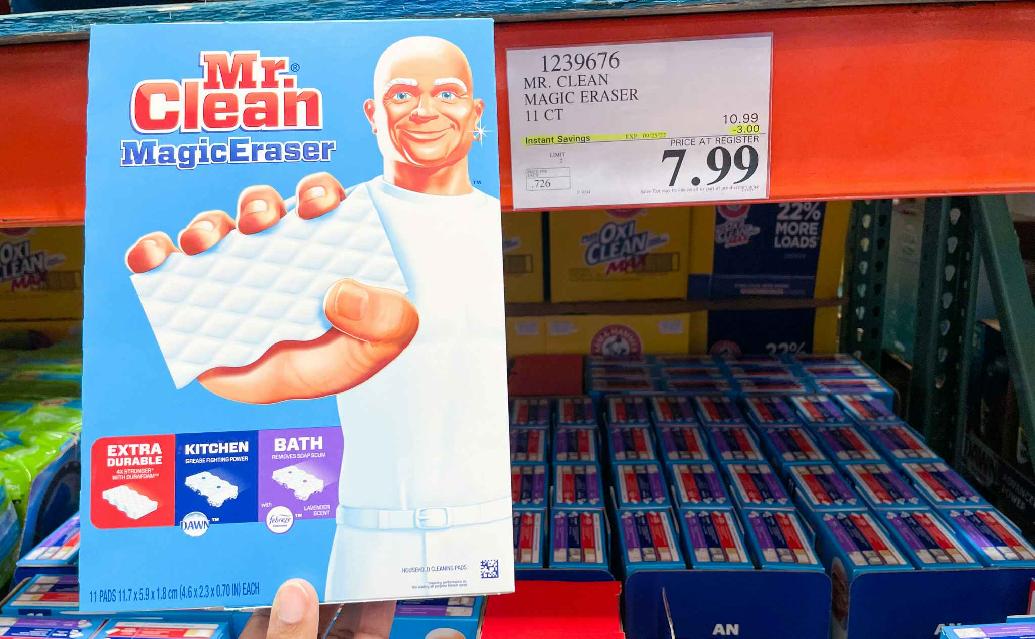 magic eraser hand held near sale sign at costco