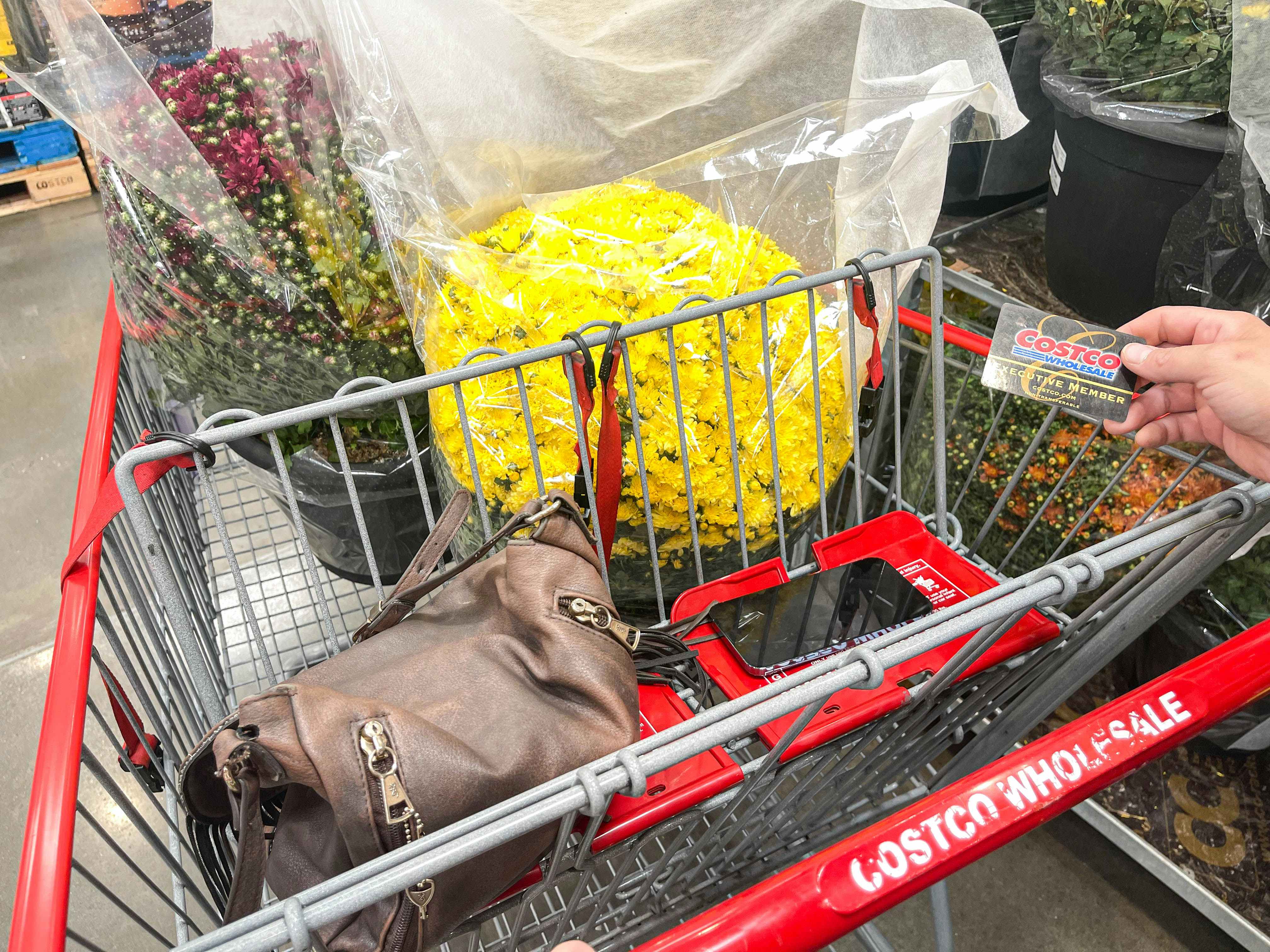 yellow mums and a purse in a costco cart