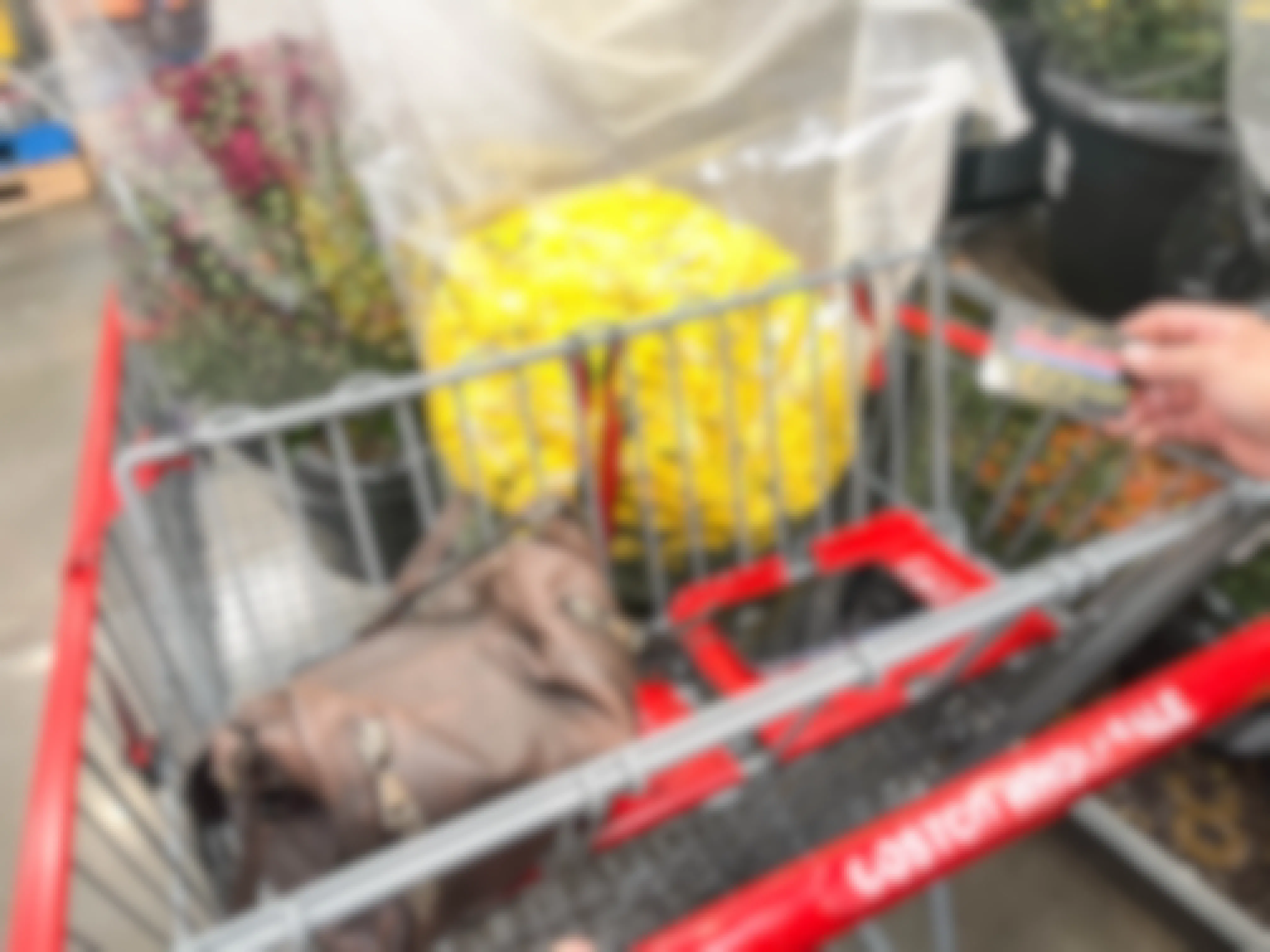 yellow mums and a purse in a costco cart