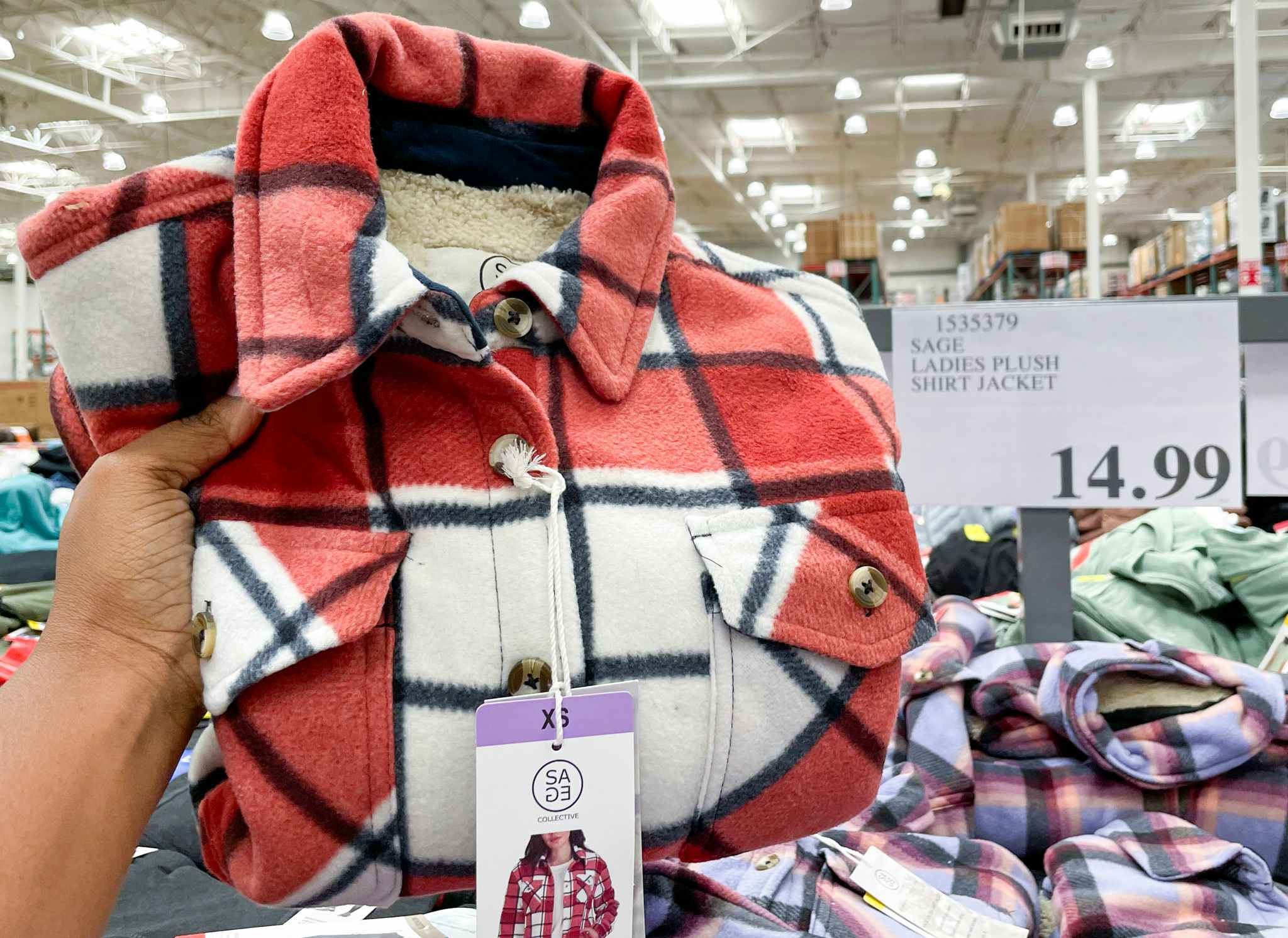 shirt jacket hand held near sale sign at costco