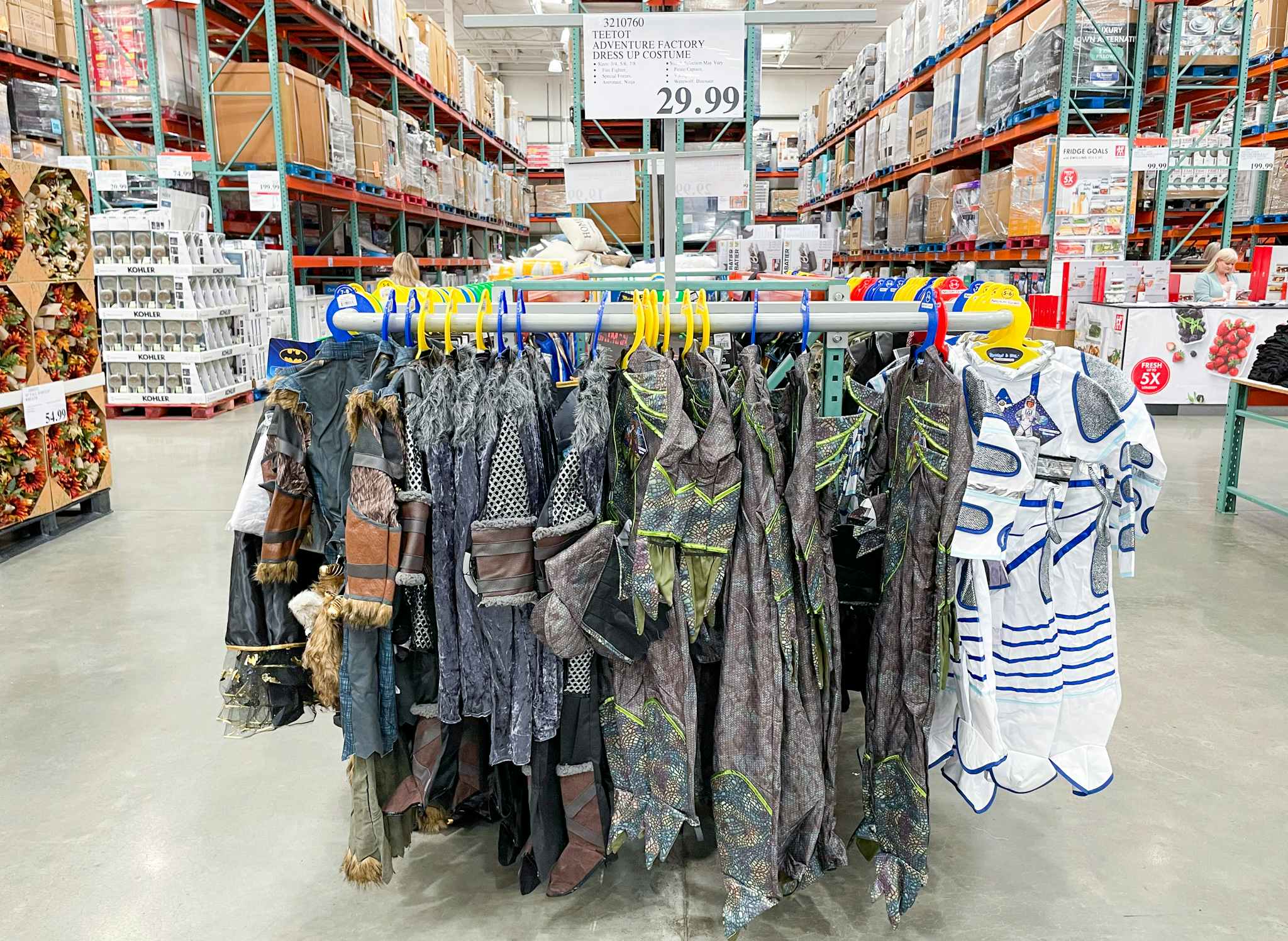 halloween costumes on a rack with sale sign at costco