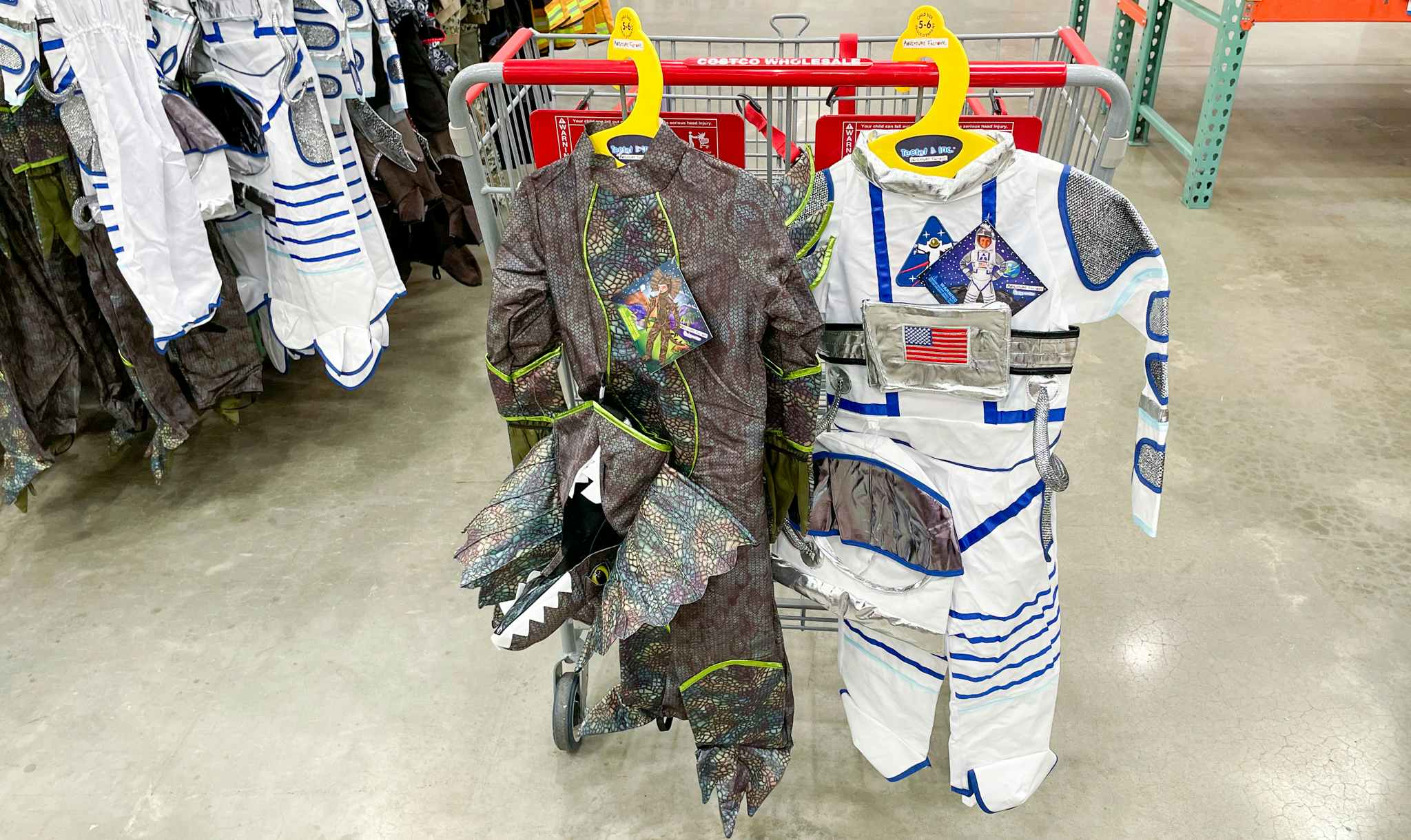 dinosaur and astronaut costumes on a cart at costco