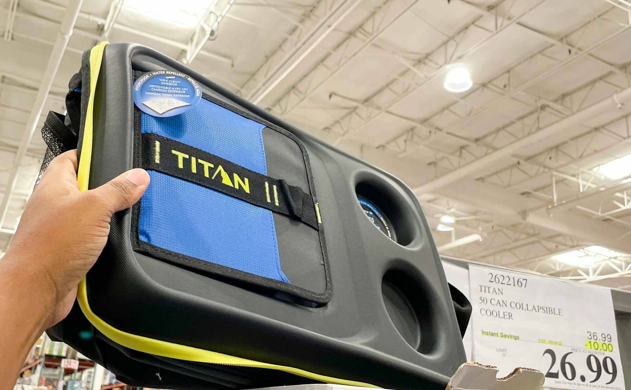 cooler hand held near sale sign at costco