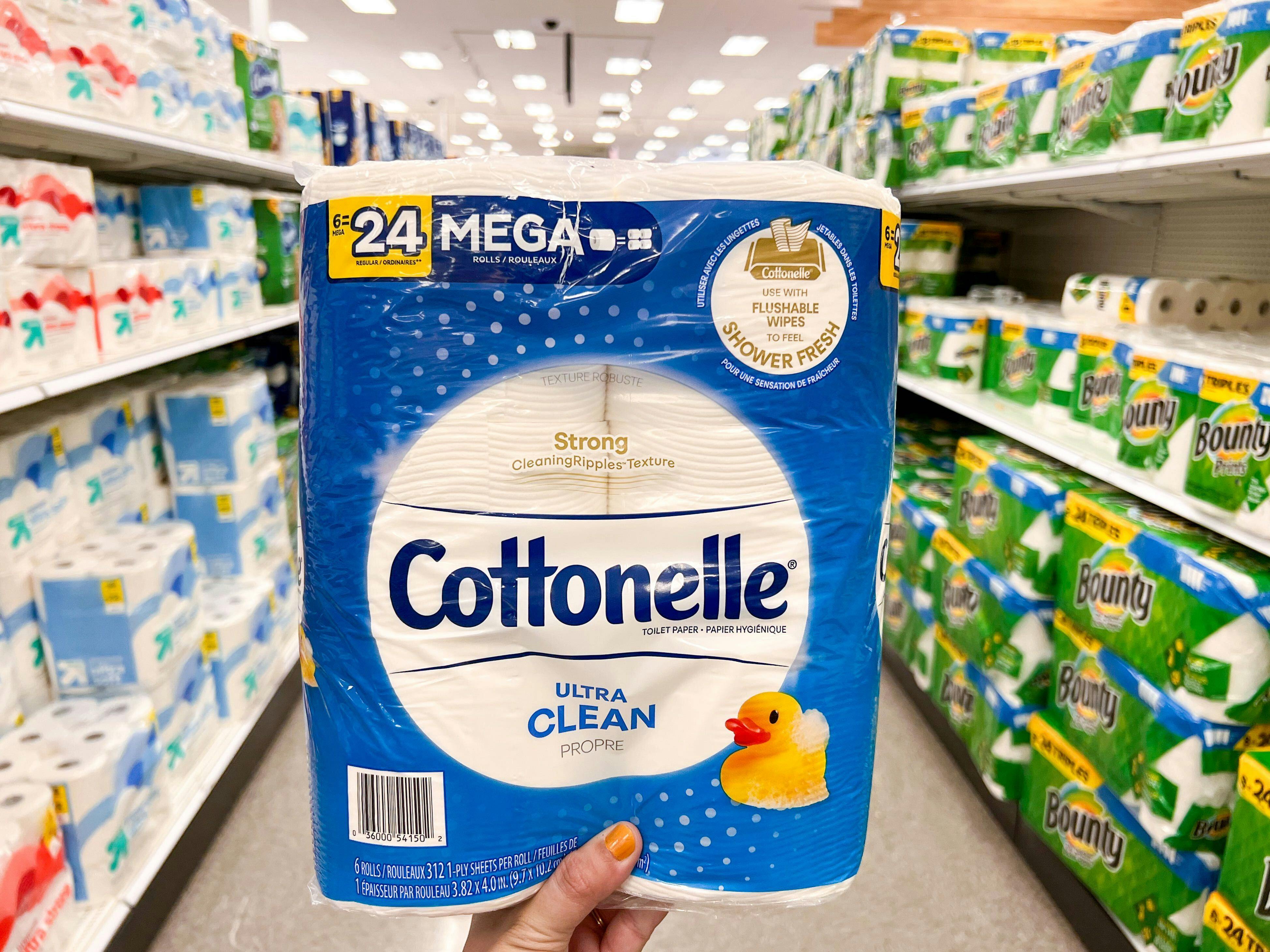 hand holding cottonelle toilet paper at target