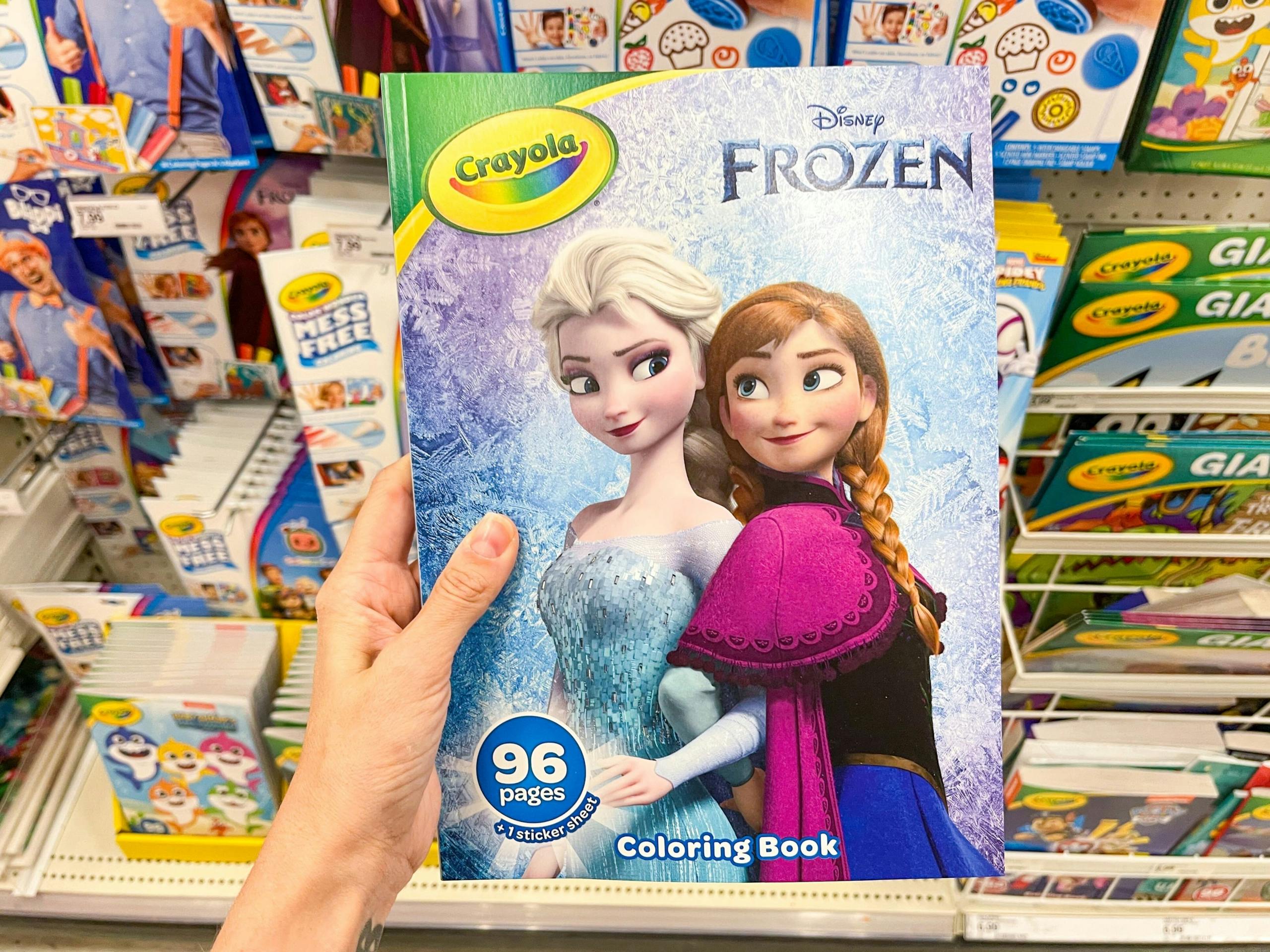 hand holding a crayola coloring book at target