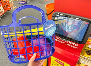 hand holding sand basket next to coupon center