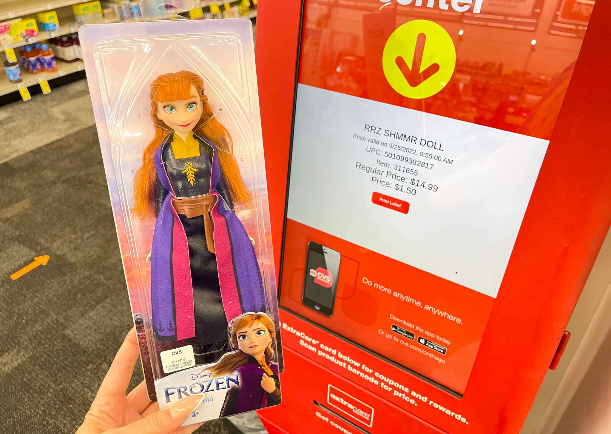 hand holding disney frozen toy next to coupon center