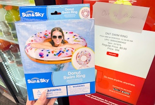 hand holding donut float next to coupon center