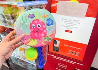 hand holding paddle game next to coupon center