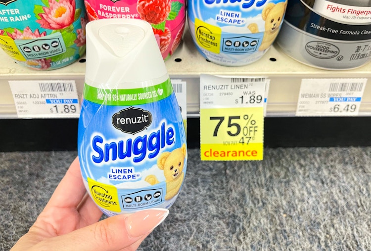 hand holding renuzit cone next to clearance tag