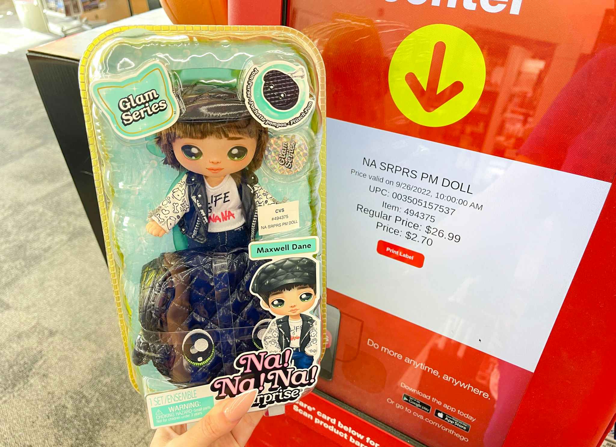 hand holding na na na surprise doll next to coupon center