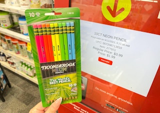 hand holding ticonderoga pencils next to cvs coupon center