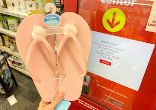 hand holding womens sandals next to coupon center