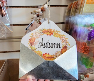 a metal mail holder that says autumn
