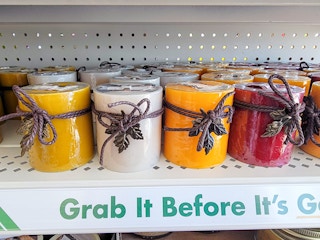 fall colored/scented candles on a shelf
