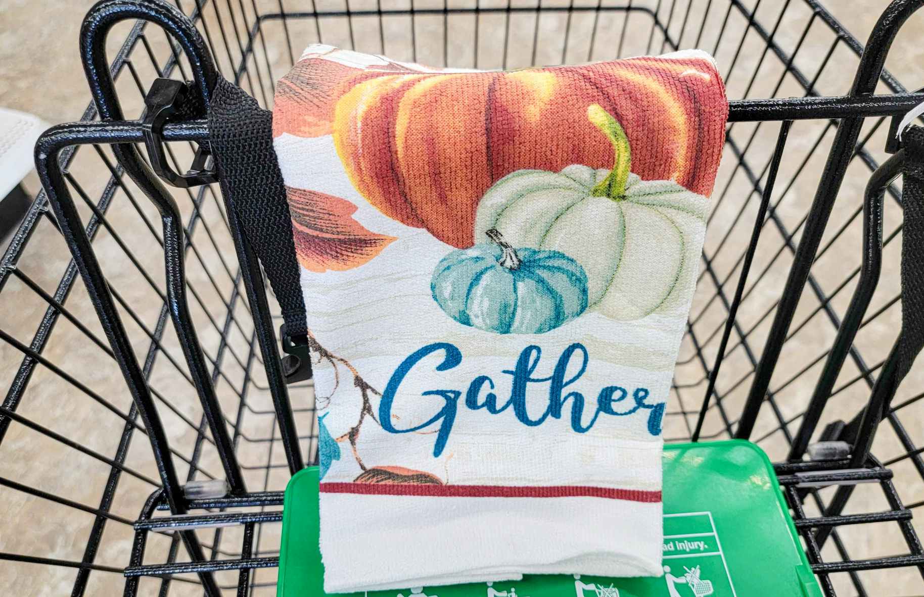 kitchen towel with pumpkins on it that says gather in a cart