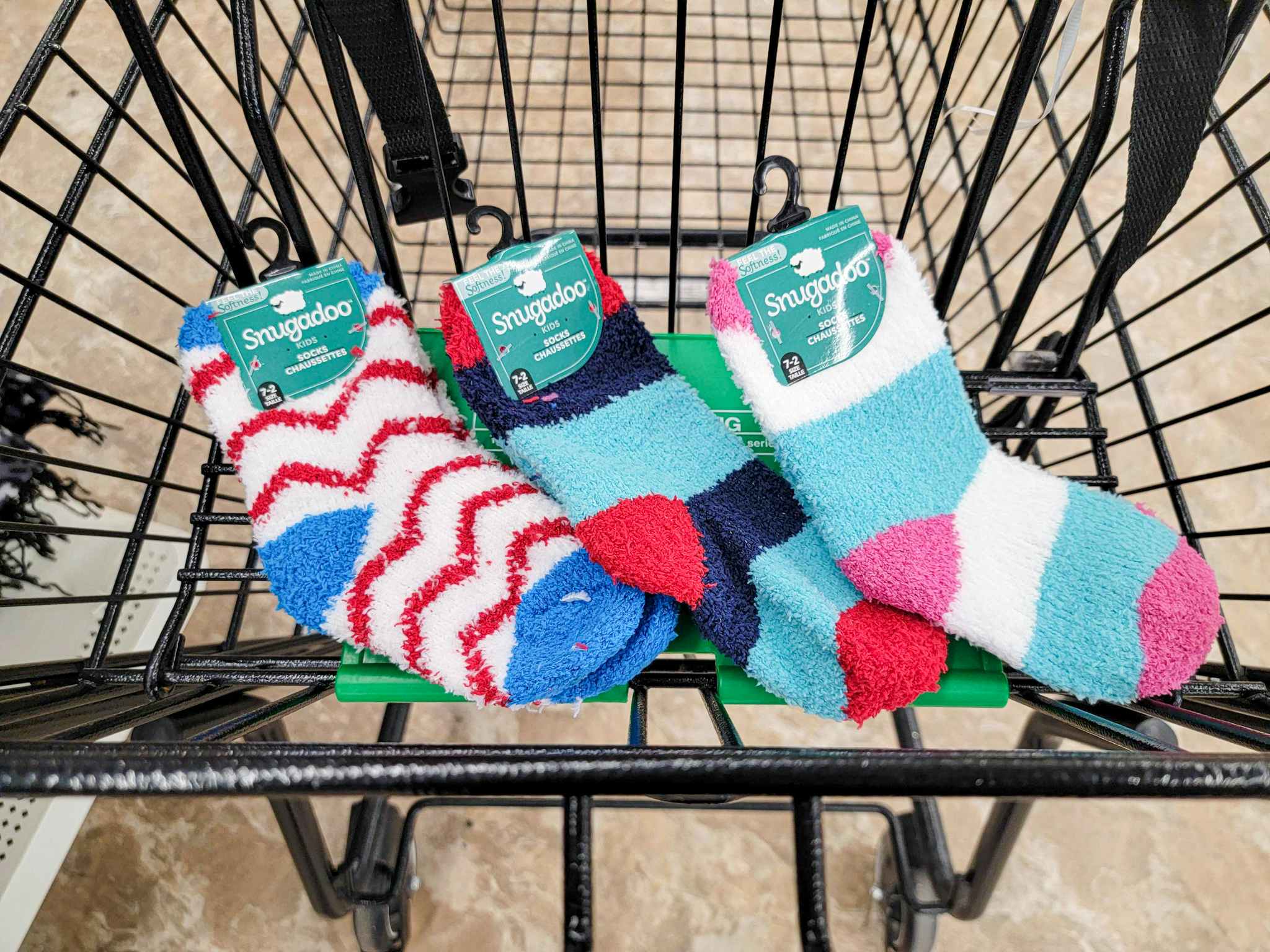 3 pairs of fuzzy kids socks in a cart