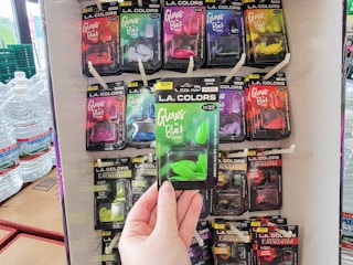 hand holding a pack of green glow in the dark nails