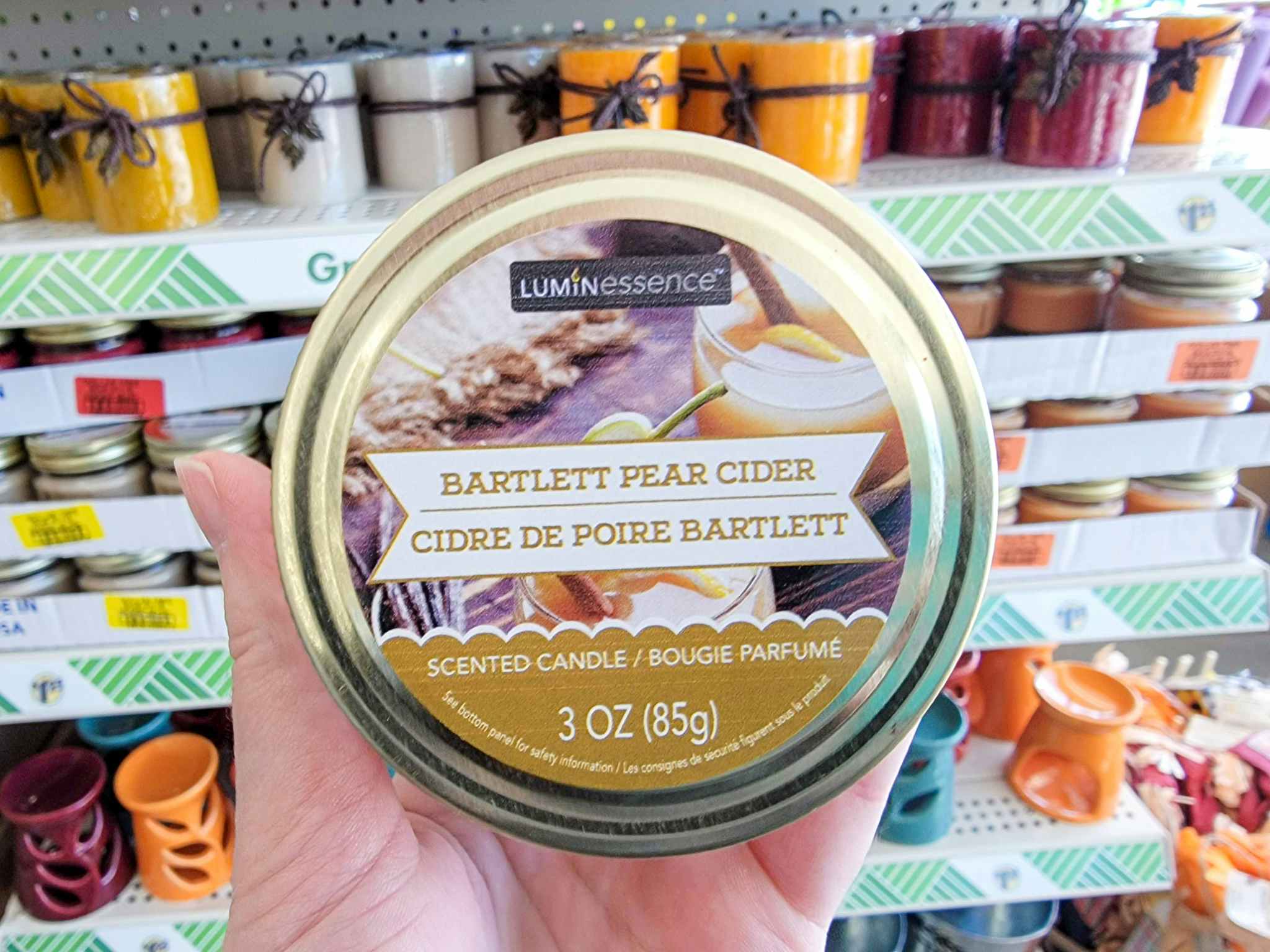 hand holding a bartlett pear cider scented candle