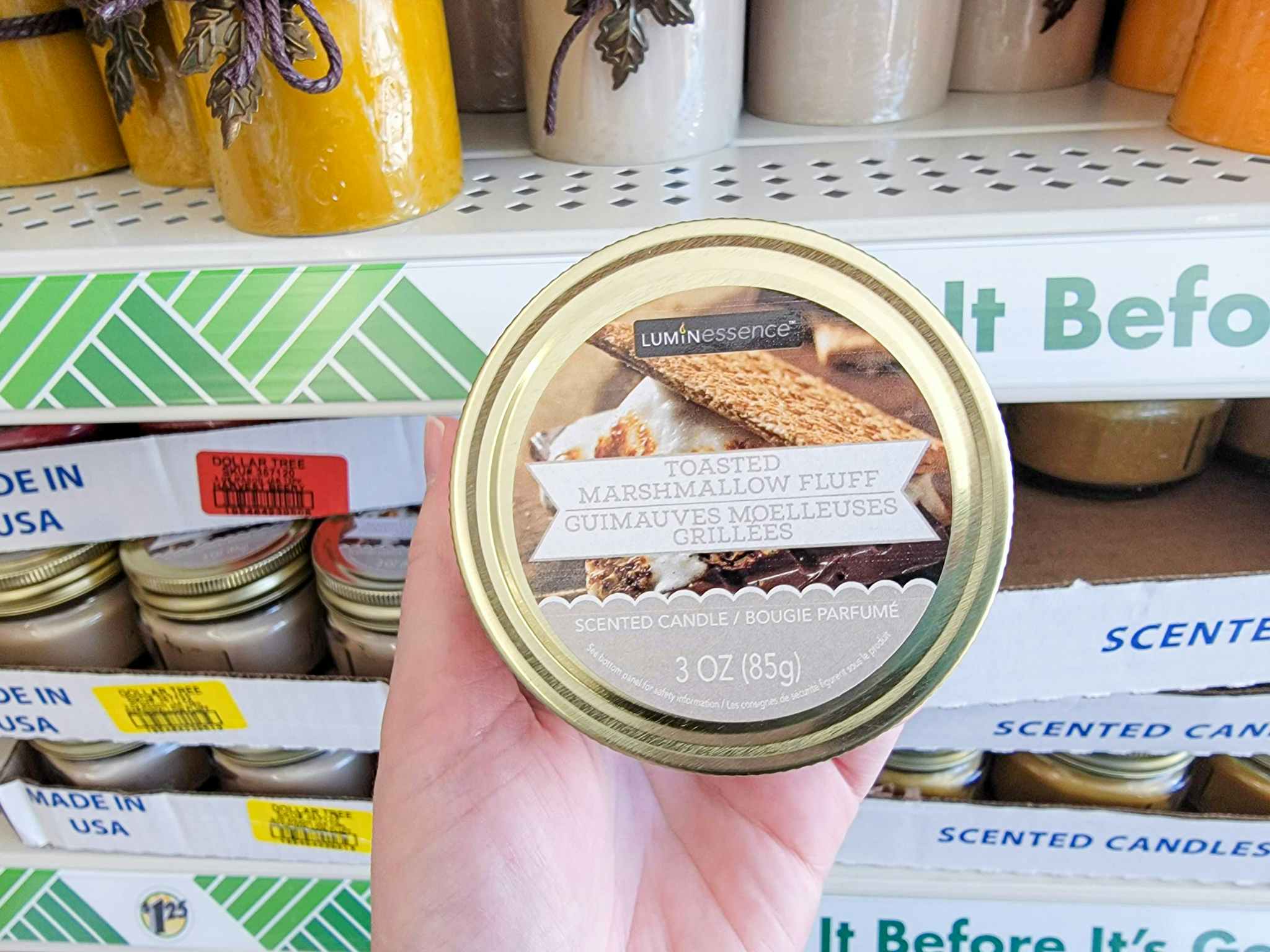 hand holding a toasted marshmallow fluff scented candle
