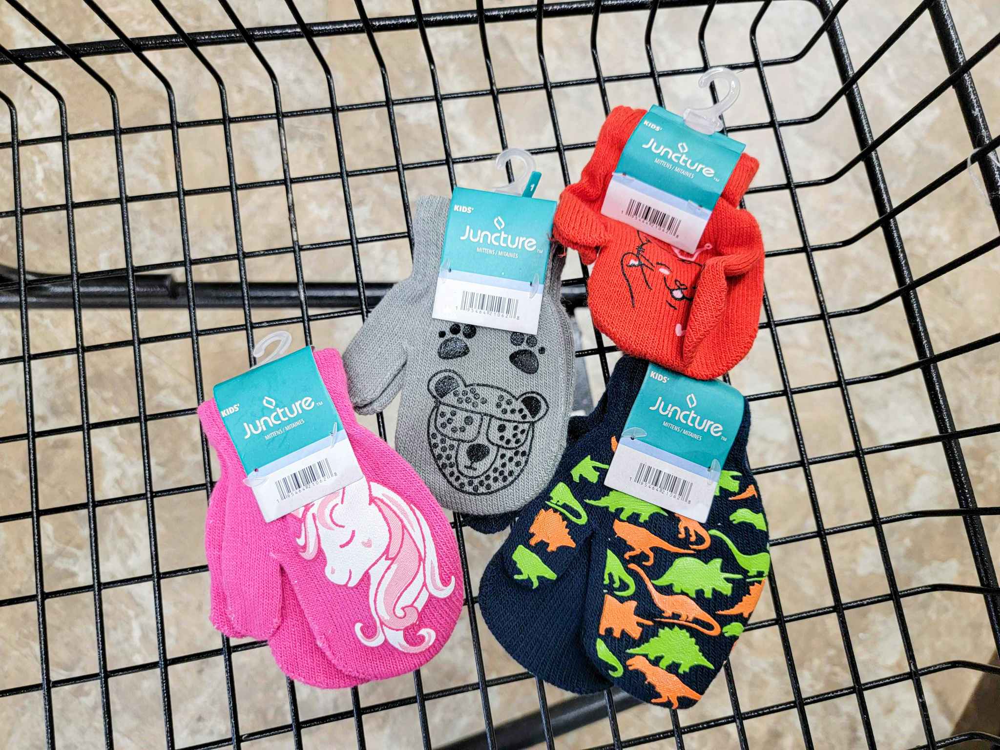four pairs of printed kids mittens in a cart