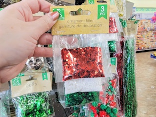 hand holding ornament filler in christmas colors