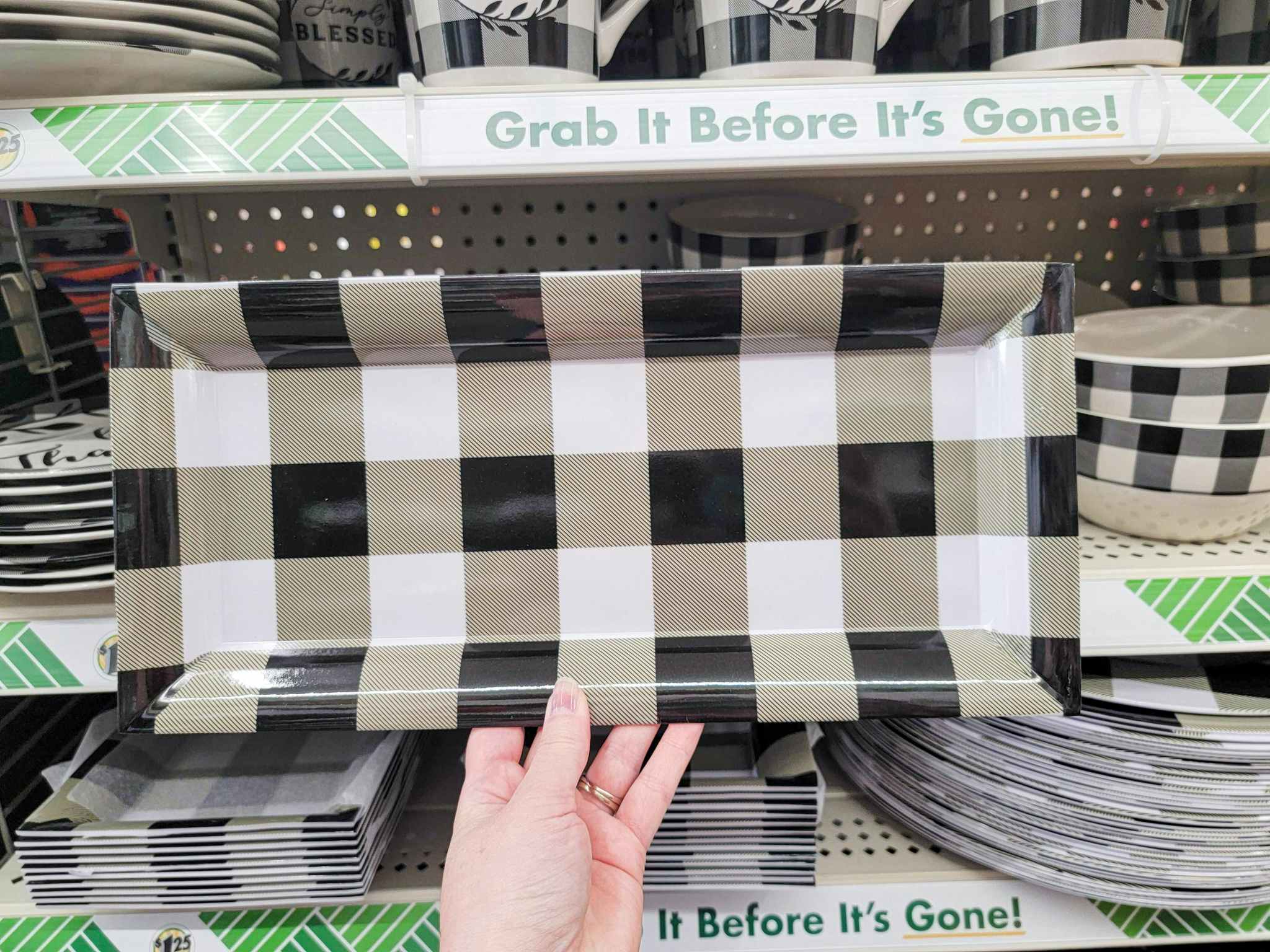 hand holding a rectangular buffalo plaid serving tray