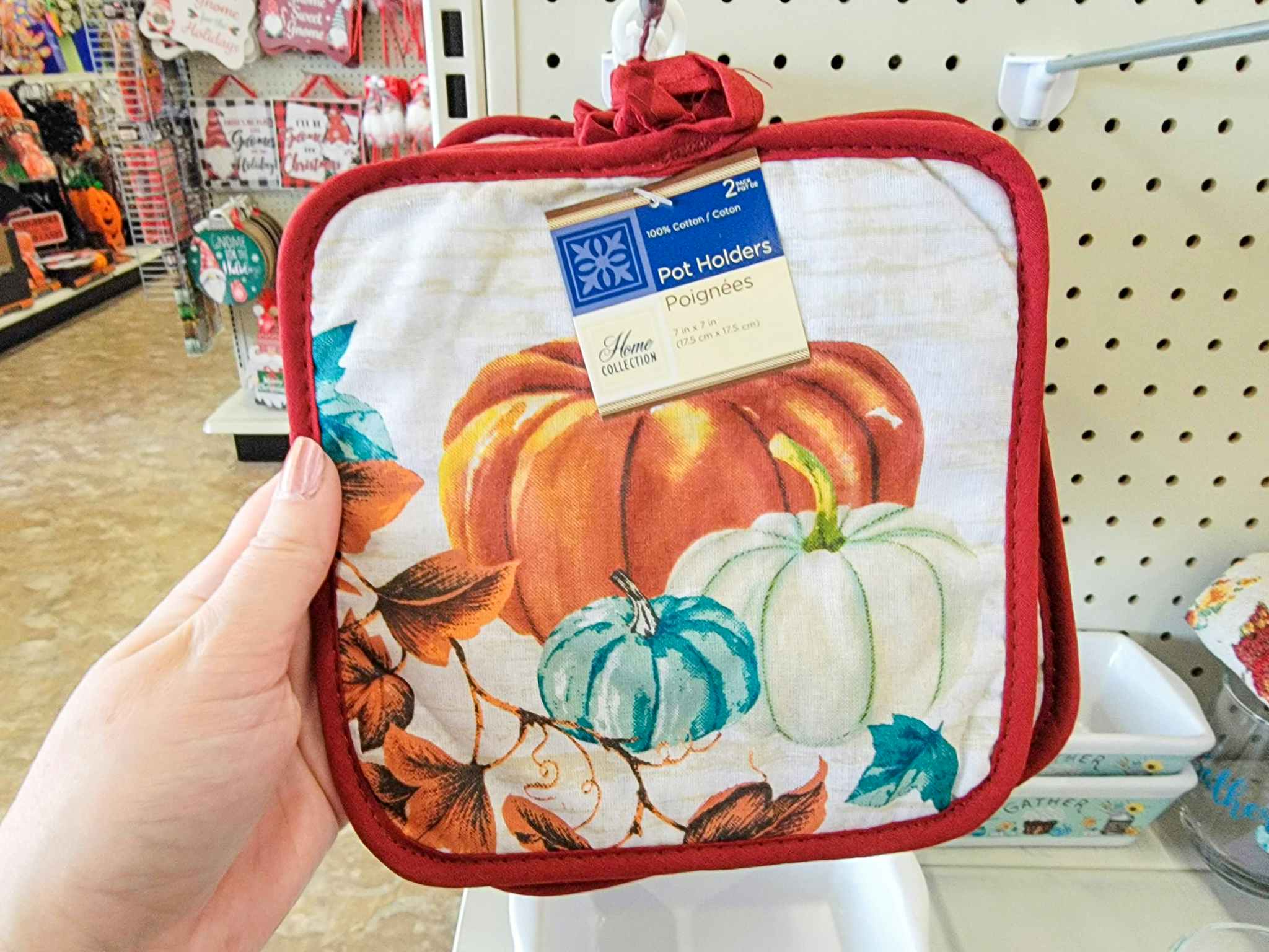 hand holding fall pumpkin pot holders