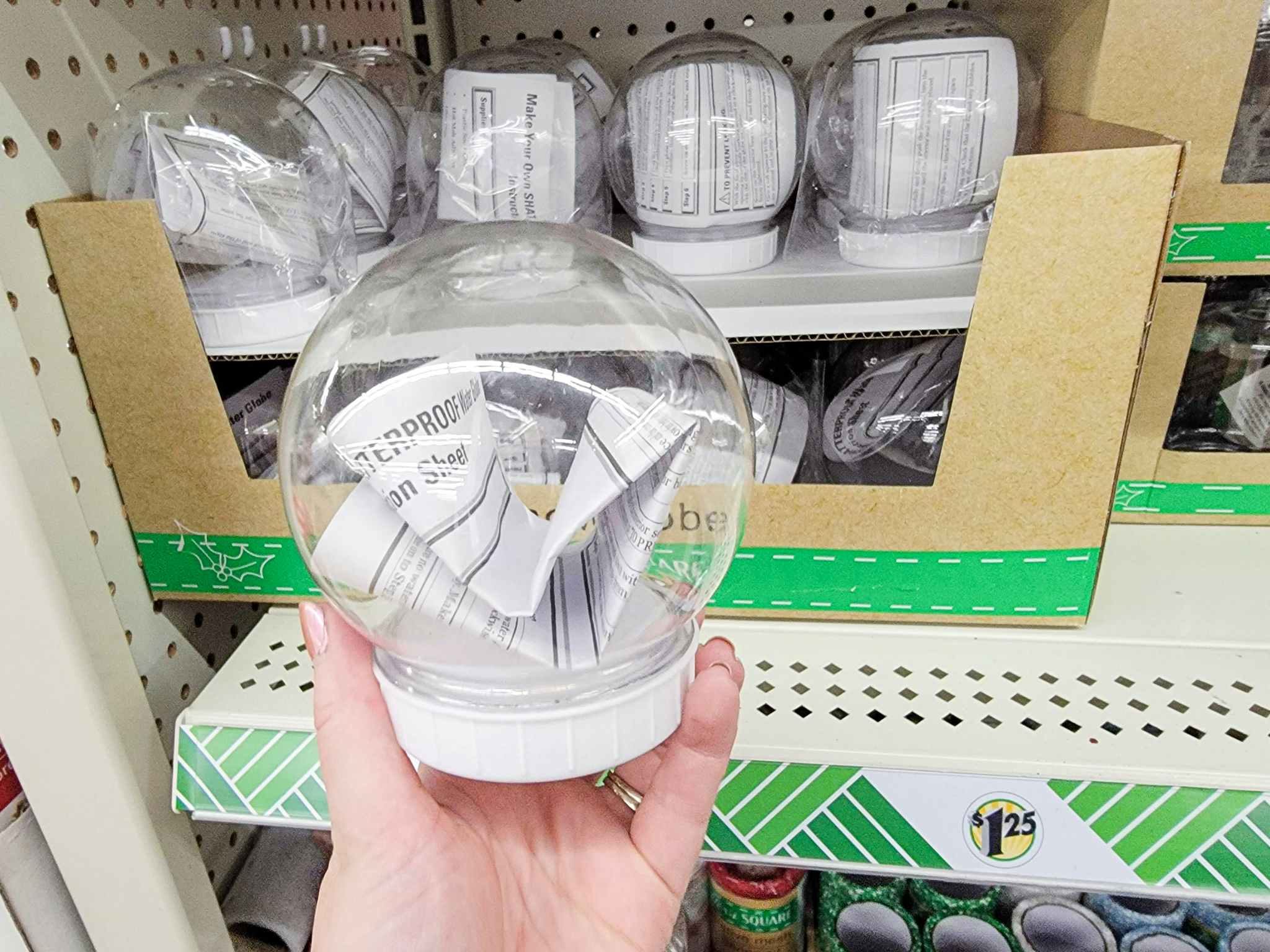 hand holding a craft snowglobe to decorate