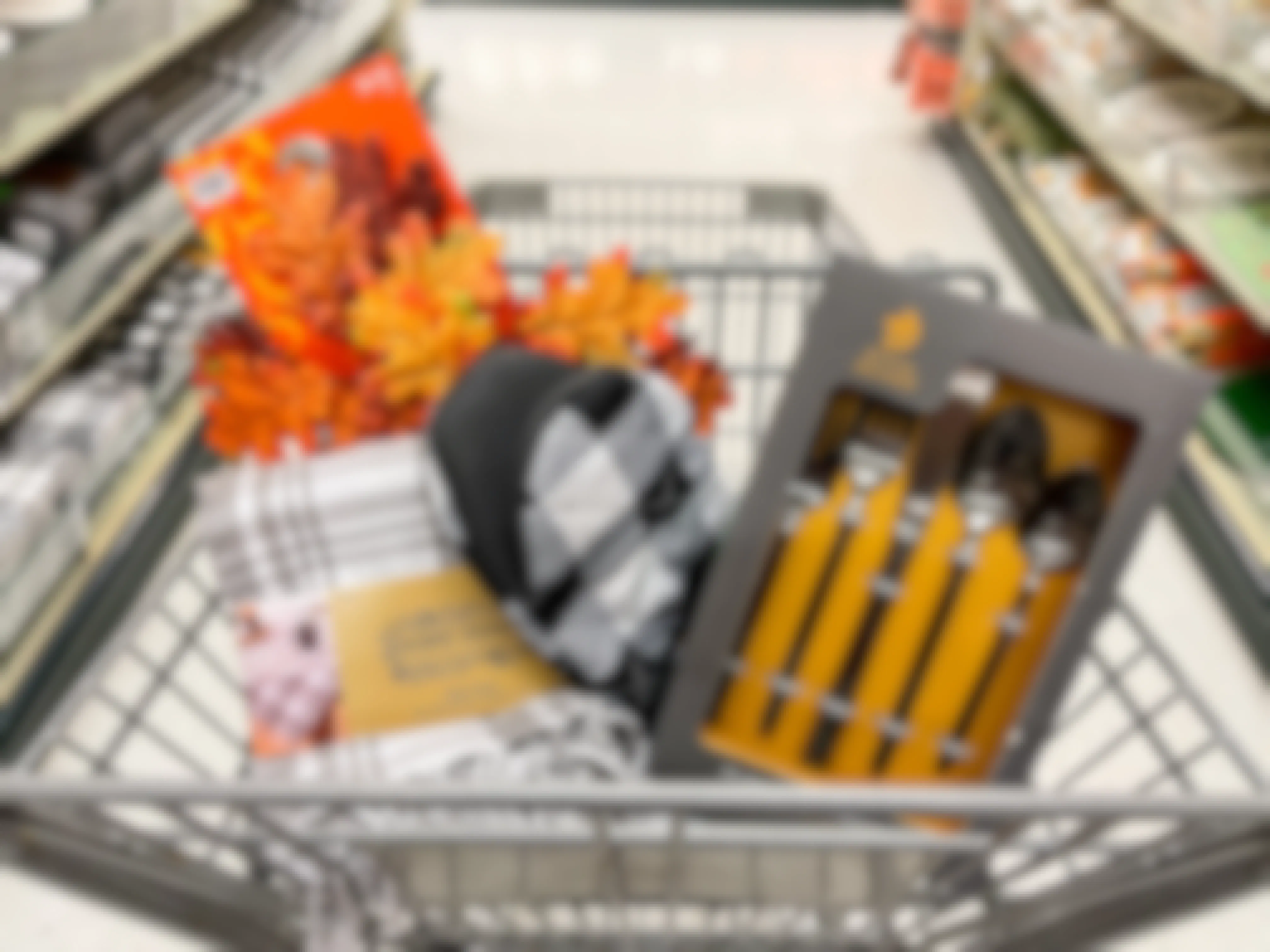 A variety of fall dining items sitting in a shopping cart.