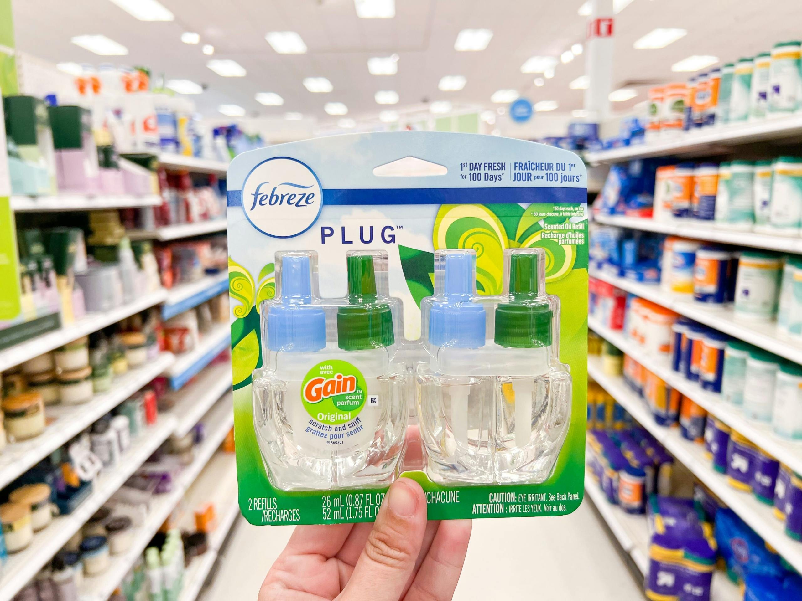 hand holding single febreze plug refills