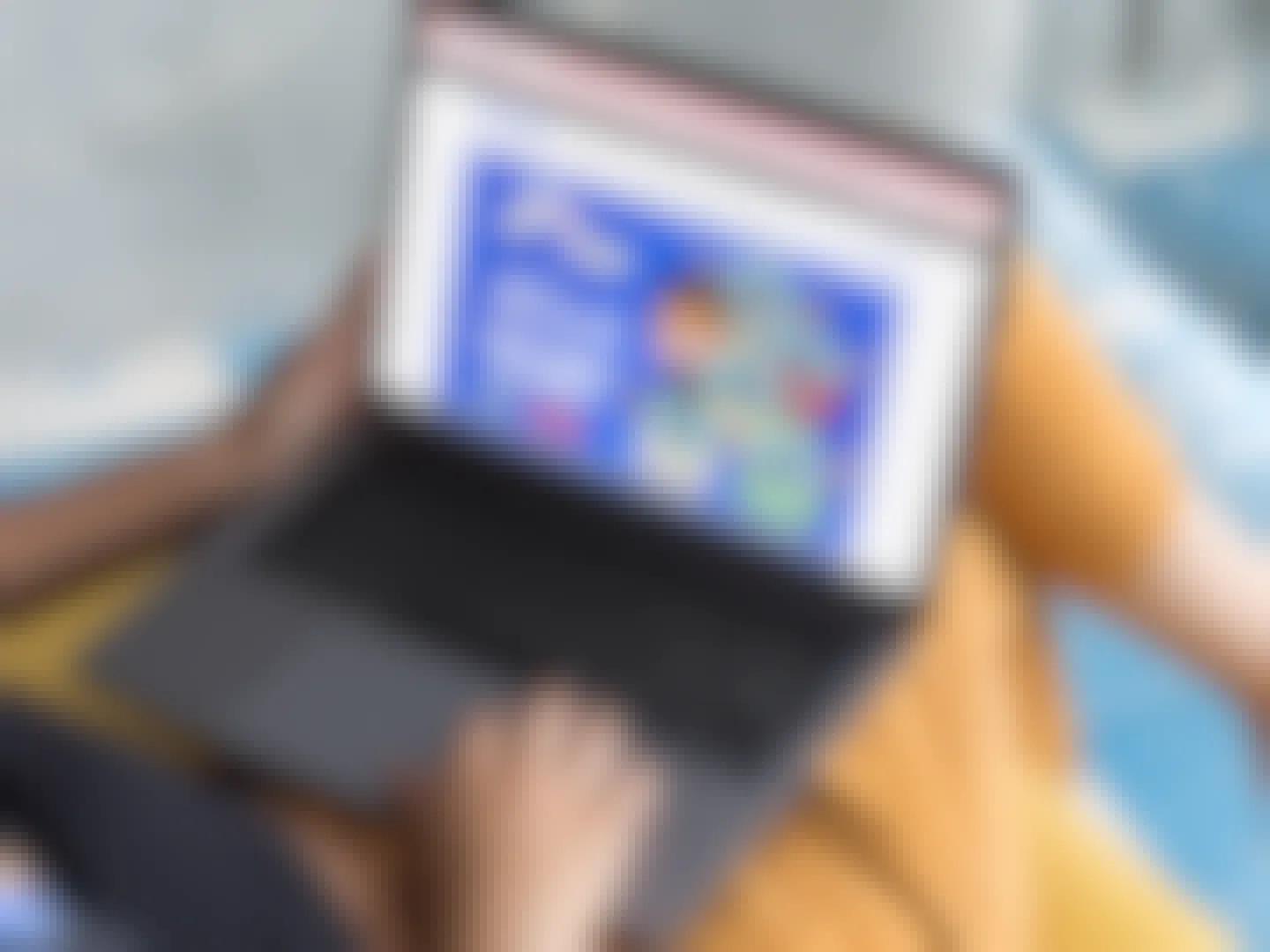 A person using a laptop looking at the Squishmallows on Five Below's website