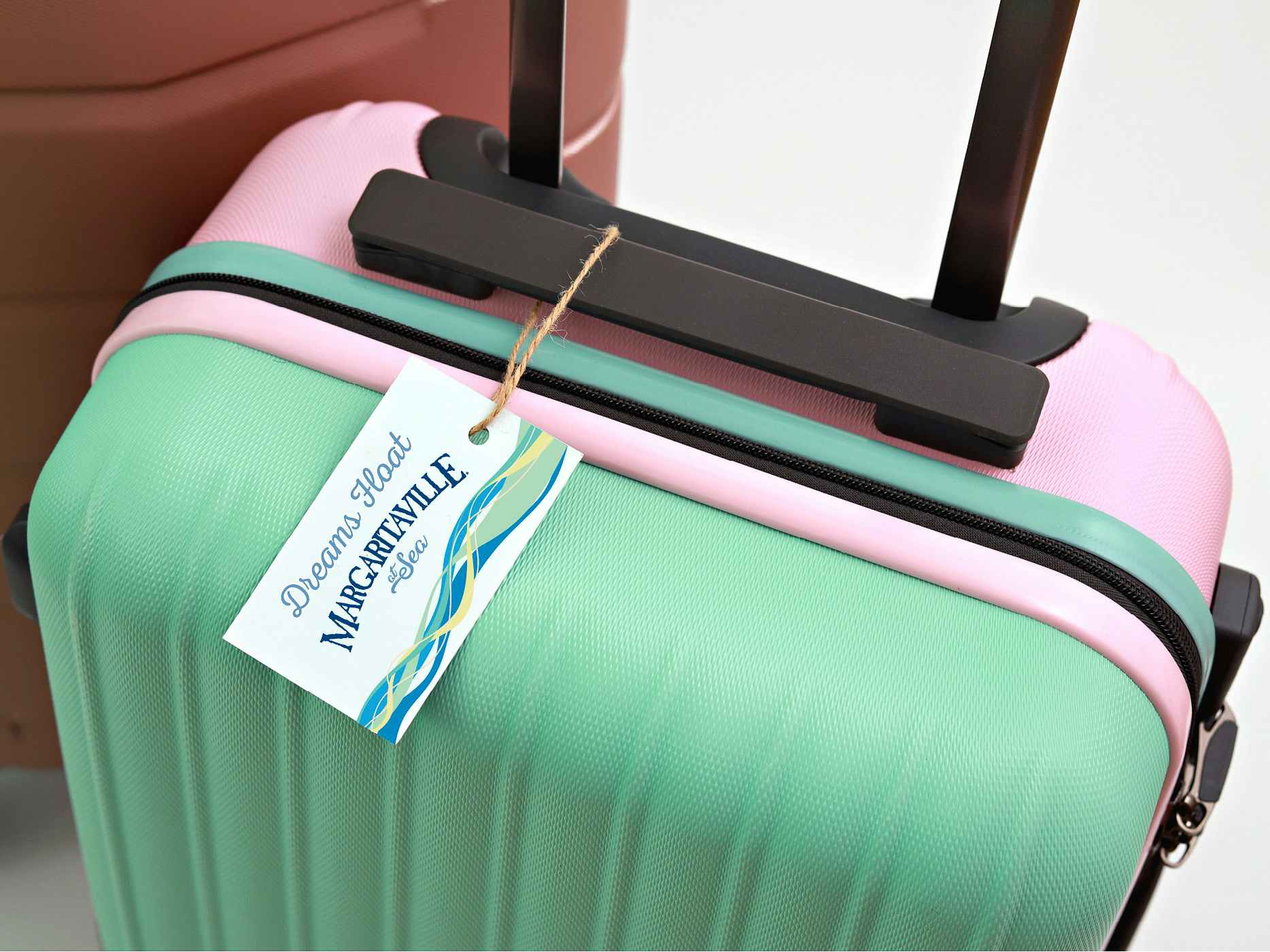 A suitcase with a tag that reads, "Dreams float. Margaritaville at Sea