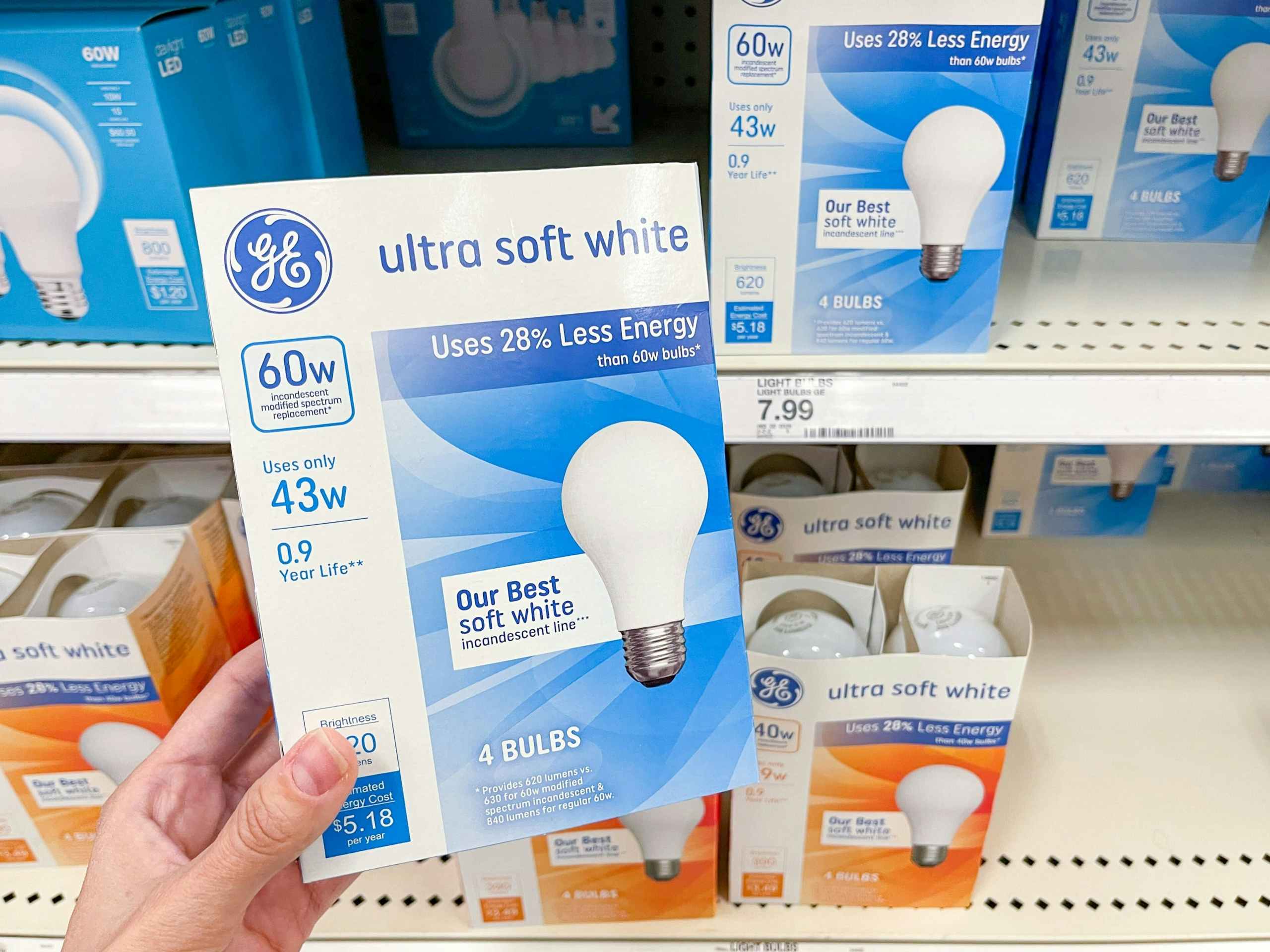 hand holding a pack of GE light bulbs at target