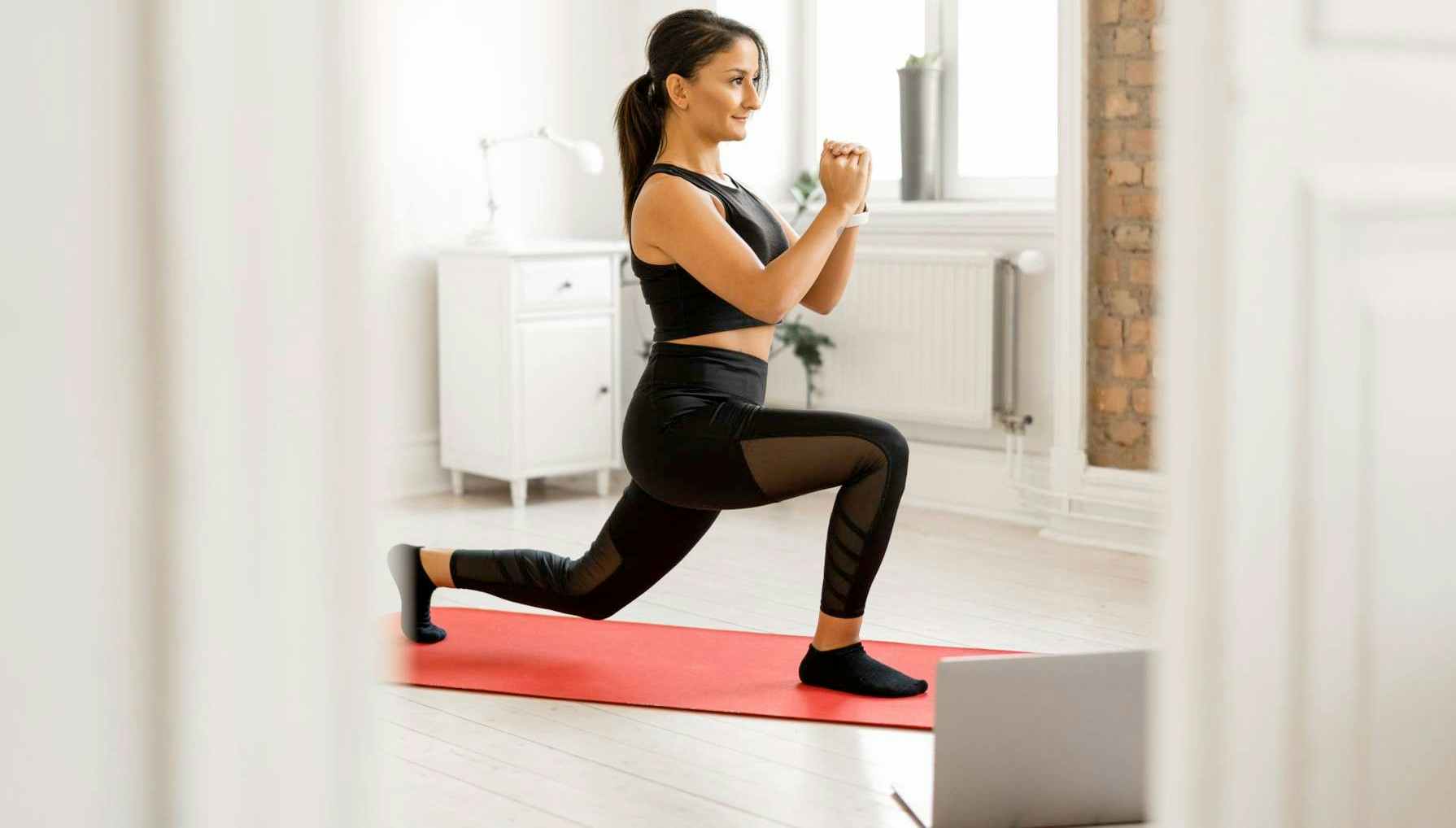 A woman doing yoga on a yoga mat.