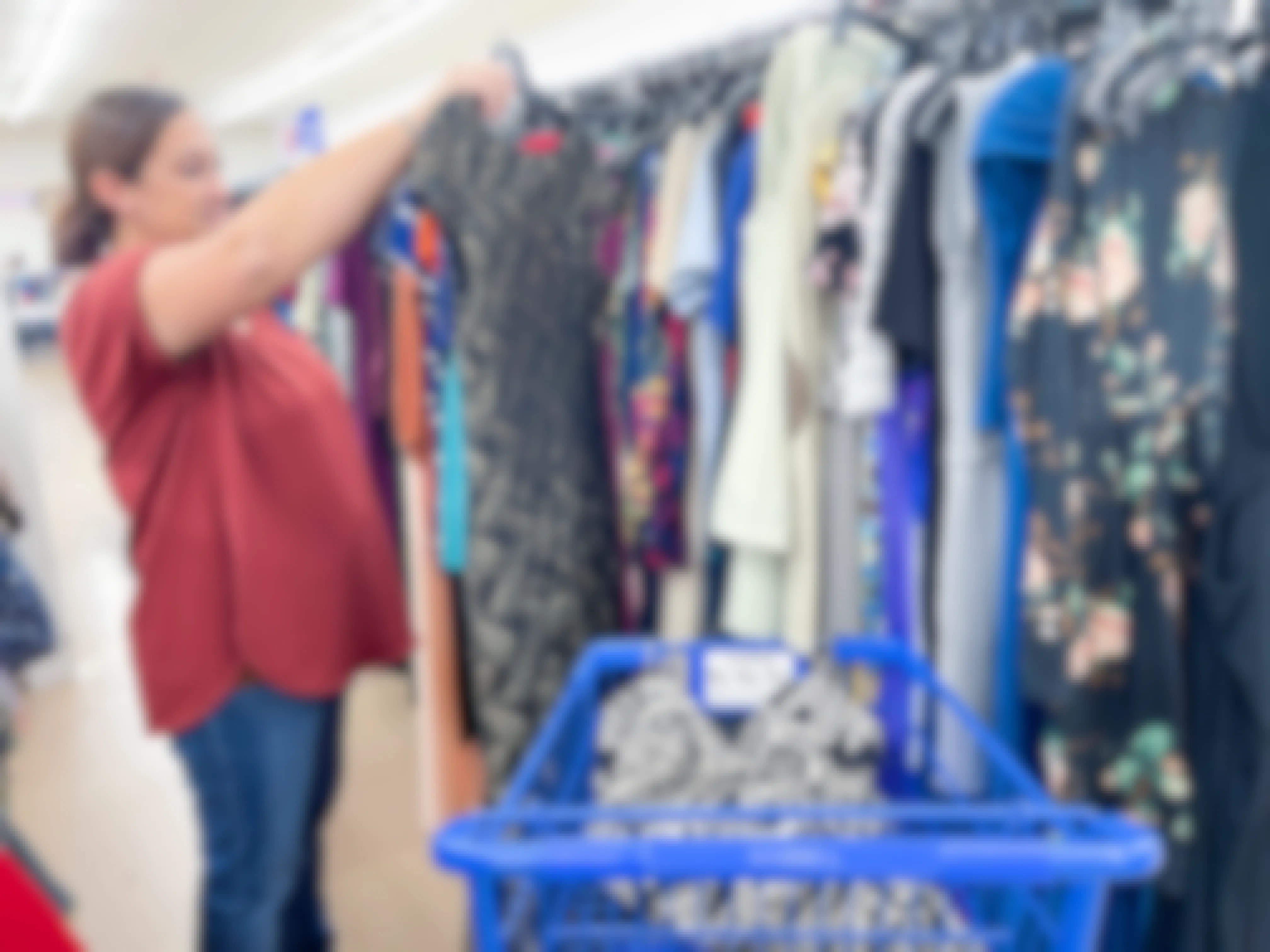 a woman shopping at goodwill looking at dresses