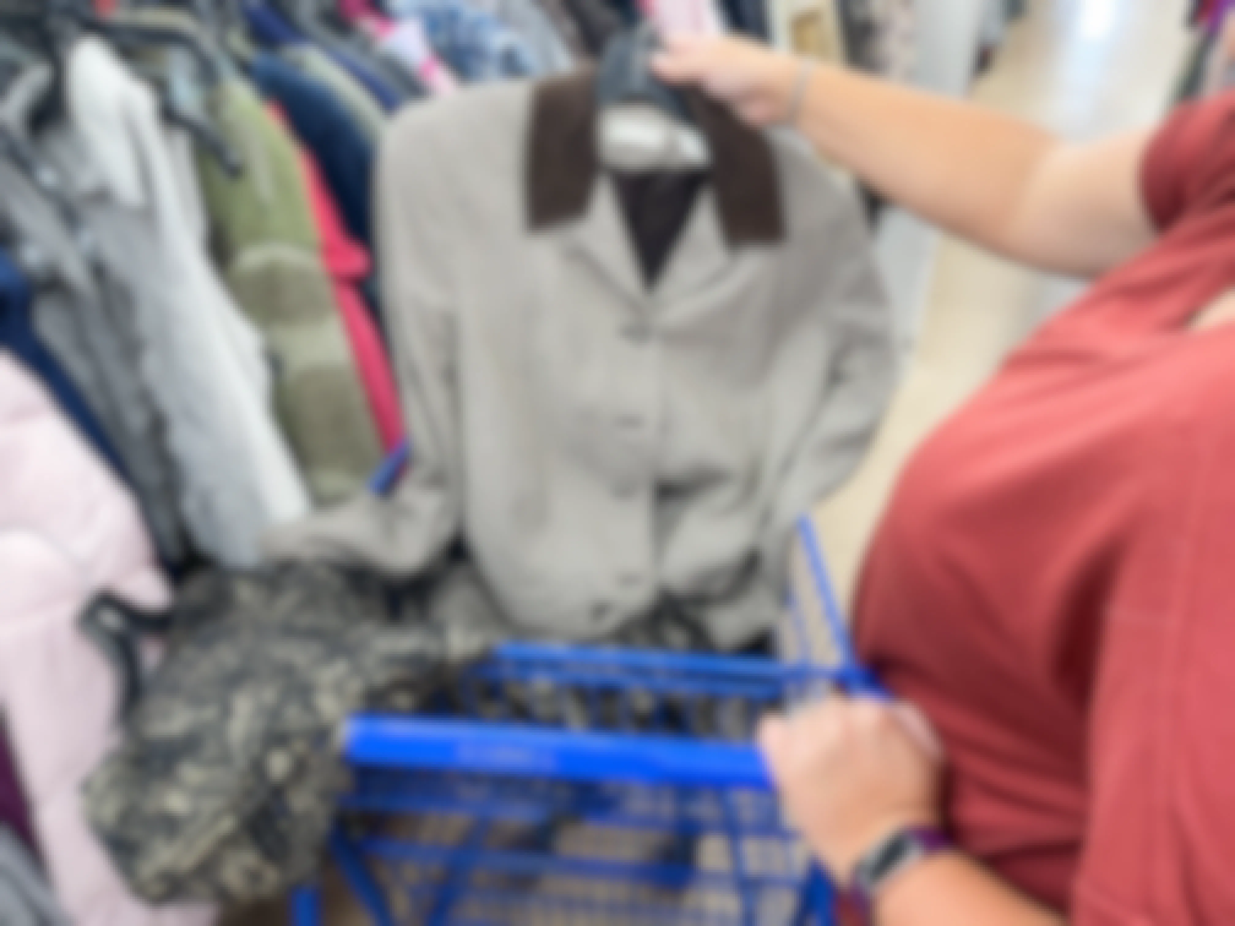 a woman shopping at goodwill looking at a blazer