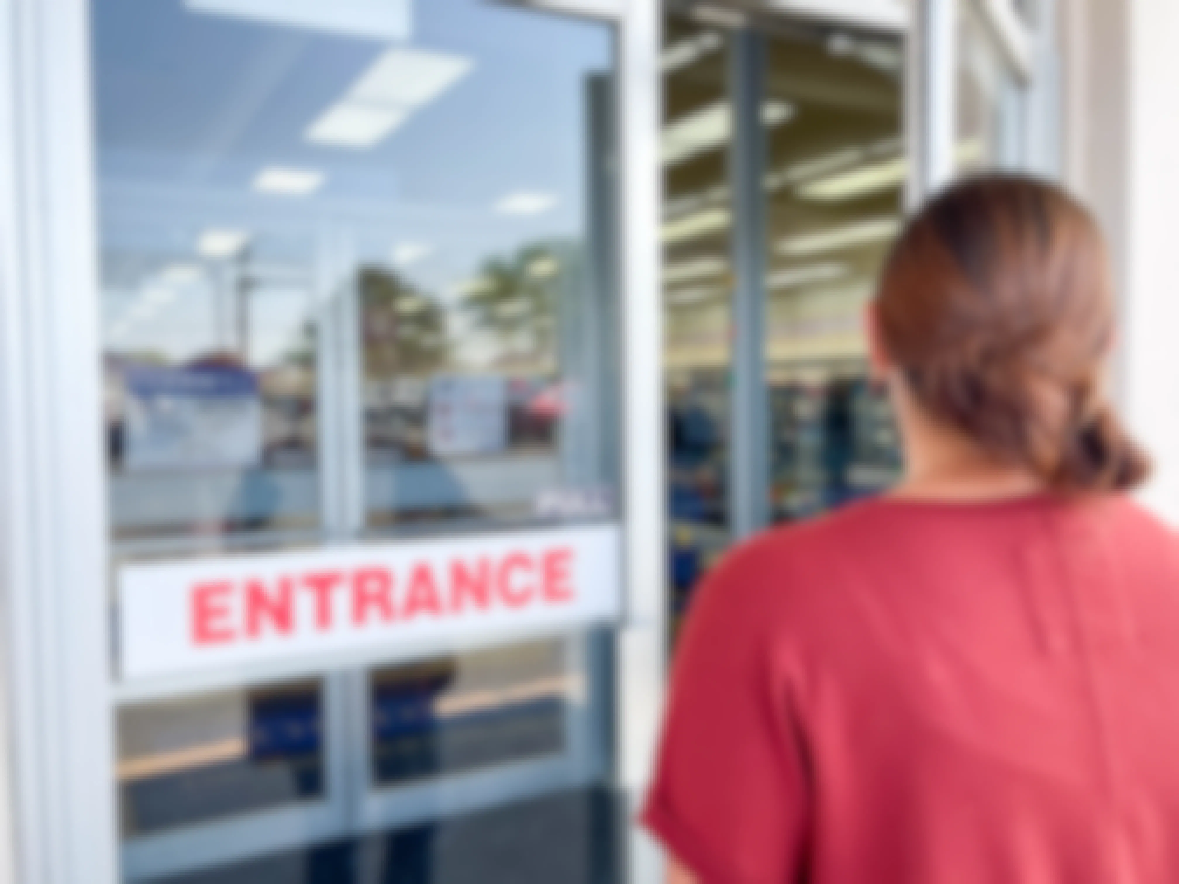 a woman going into entrance of goodwill